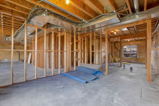 House interior under construction with air conditioning ducts on the ceiling