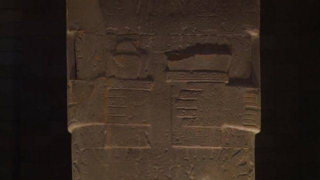 Extreme low angle front-view tilting shot of carvings on the  Bennett Monolith displayed at Tiwanaku museum, Al Paz, Bolivia