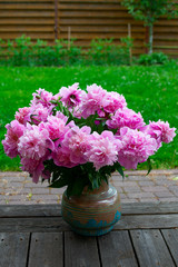 bouquet of peonies in vase in garden