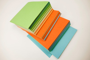 A stack of multicolored note papers on an isolated white background. isolates
