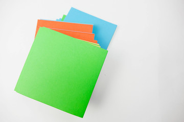 A stack of multicolored note papers on an isolated white background. isolates