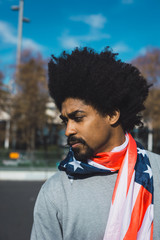 Man with afro hair proudly showing the American flag