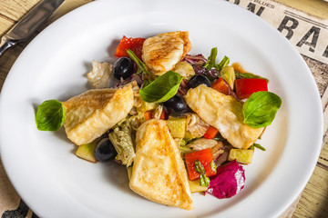 salad of fried chicken, basil, olives, pepper and onion