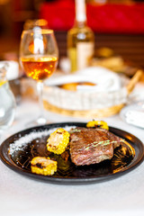 Grilled steak with corn and rosemary. Restaurant serving