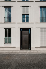 Fototapeta na wymiar entrance door on modern building with empty street -