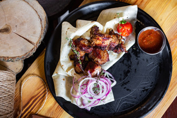 Barbecue with onions in pita bread and sauce