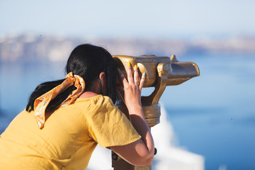 Beautiful young woman viewing amazing seascape through binoculars, enjoying vacation  © happyimages