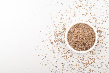 ajwain ammi trachyspermum in white bowl isolated on white background, indian spices.
