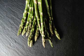 green asparagus on slate plate