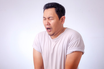 Fototapeta premium Funny Asian Man Crying When Peeing