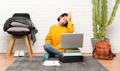 Asian young woman sitting on the floor having doubts with confuse face expression