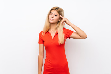 Teenager girl over isolated white background making the gesture of madness putting finger on the...