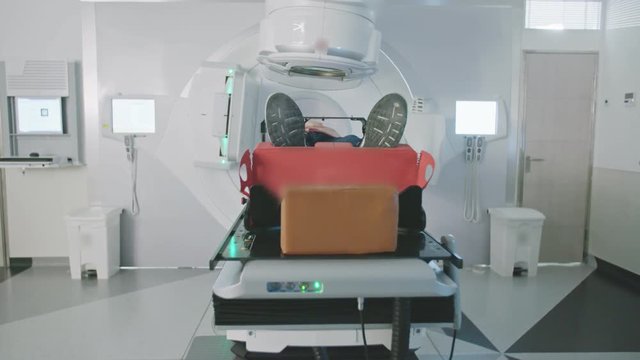 Patient Getting Radiation Therapy Treatment Inside A Modern Radiotherapy Room