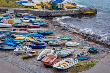 Fototapeta na wymiar Small fishing boats in port of Aci Castello town on Sicily Island, Italy