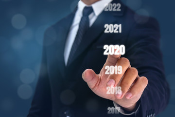 Obraz premium 2020 concept, man hand try to point new year coming 2020