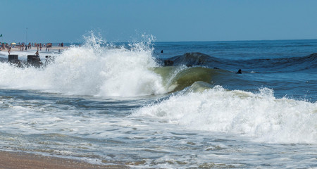 Waves crashing on beach on a summer day