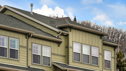 Panorama Exterior view of the upper storey of a house against cloudy blue sky in winter