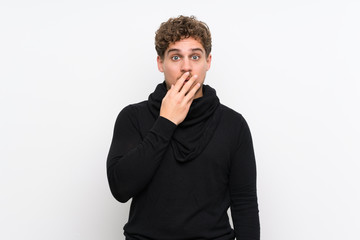 Blonde man over isolated white wall surprised and shocked while looking right