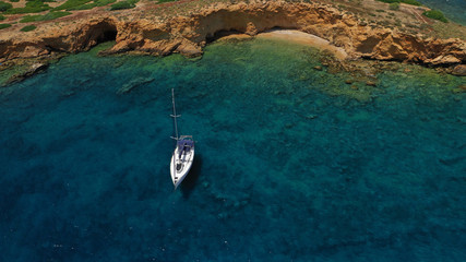 Aerial view of small islet of Ydrousa with turquoise and sapphire clear waters and only one mile...
