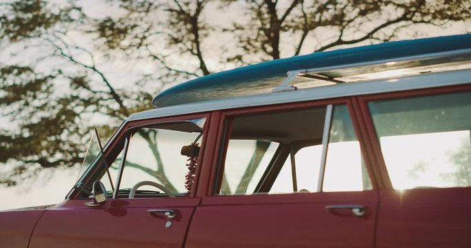 Shot of vintage beach cruiser at sunset with a longboard surfboard and flower lei, vintage hawaiian surf adventure