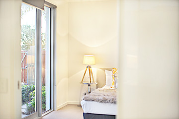 Looking to the modern bedroom entrance with a yellow  lamp