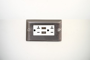 Outlet on white wall isolated with USB option and power USA