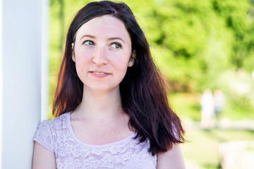 Happy caucasian woman outdoors in the park looking away