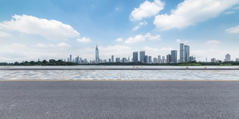 Fototapeta premium Panoramic skyline and modern business office buildings with empty road,empty concrete square floor