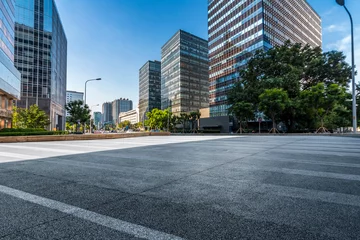 Tuinposter Panoramic skyline and modern business office buildings with empty road,empty concrete square floor © MyCreative