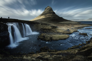Beautiful scenery of Kirkjufell mountain and Kirkjufellfoss waterfall in Iceland is famous natural landmark and very popular for photographers and tourists. Attractions and travel concept