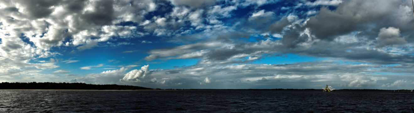 Magnificent white nimbostratus cloud in blue sky. Australia.