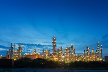Fototapeta premium Big industrial oil tanks in a petrochemical plant at sunset