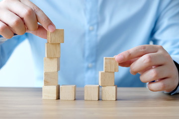 Man hand holding blank wooden cubes on table background, business concept background, mock up, template