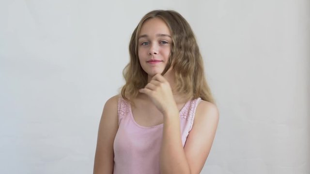 close-up of a teenager girl model with long hair posing on a white background