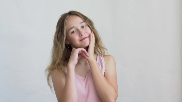 close-up of a teenager girl model with long hair posing on a white background