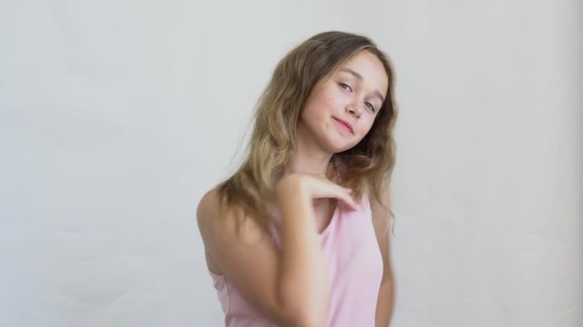 close-up of a teenager girl model with long hair posing on a white background