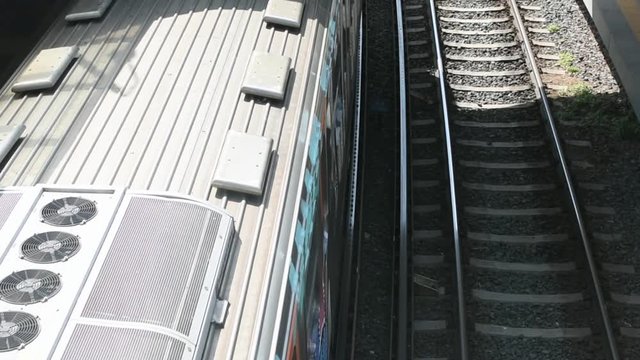 Top of a train while departure from train station daylight