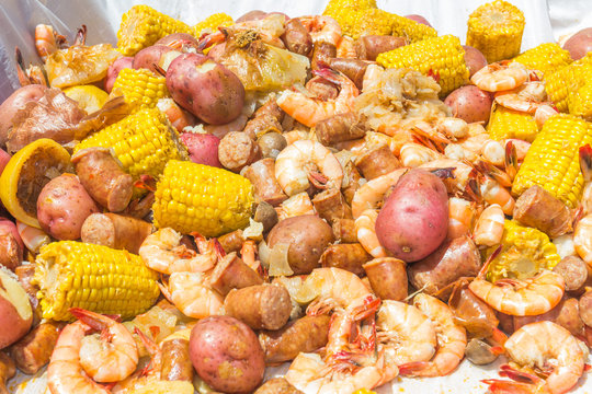 Shrimp Boil Heap: Shrimp boil heap with corn, baby potatoes, mushrooms, sausage, and lemons.