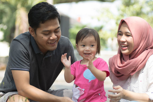 Happy Young Muslim Family With One Children Playing At Park Laughing In Sunny Day