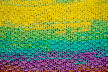 Fototapeta na wymiar multicolor yellow, green, orange and purple horizontal knitted pattern background