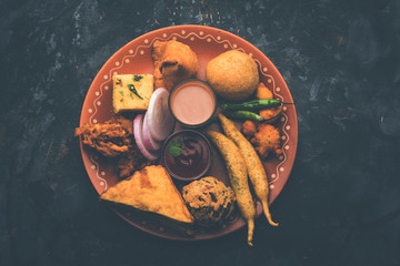 Indian Tea time snacks  in group includes Veg Samosa, Kachori/kachaudi, aloo bonda, khaman dhokla,...