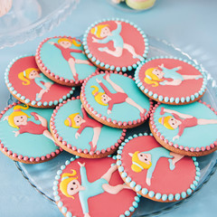 Rhythmic gymnastics Candy Bar. Delicious sweet buffet. Decorated cookies. Glazed Rhythmic gymnastics shaped cookies for children birthday party.  Catering buffet for events.