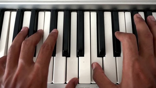 Hands of a man on a piano keys. Slow, easy and beginner's level.
