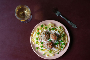 Pasta with meatballs on a dark background
