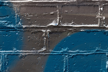 Brick wall painted in different colors close up. Abstract background