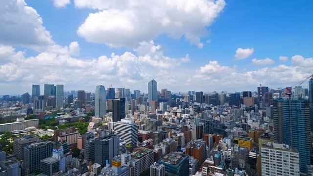 Birdseye view of Tokyo City on a sunny day with clouds rolling through the timelapse