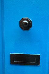 Door handle and the letter box on the bright blue wooden door, Valletta, Malta