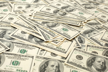 Canvas money sack with one hundred dollar bills 