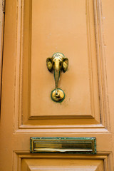 vintage bronze elephant head knocker on wooden door with mail slot, Victoria, Gozo, Malta