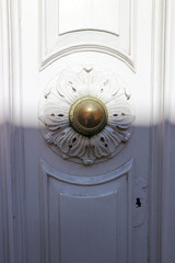 old wooden door with round door handle and wood carving, Valletta, Malta